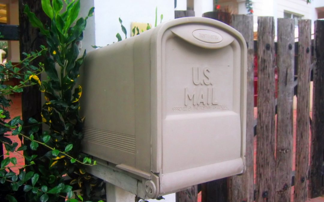 A mailbox by a fence